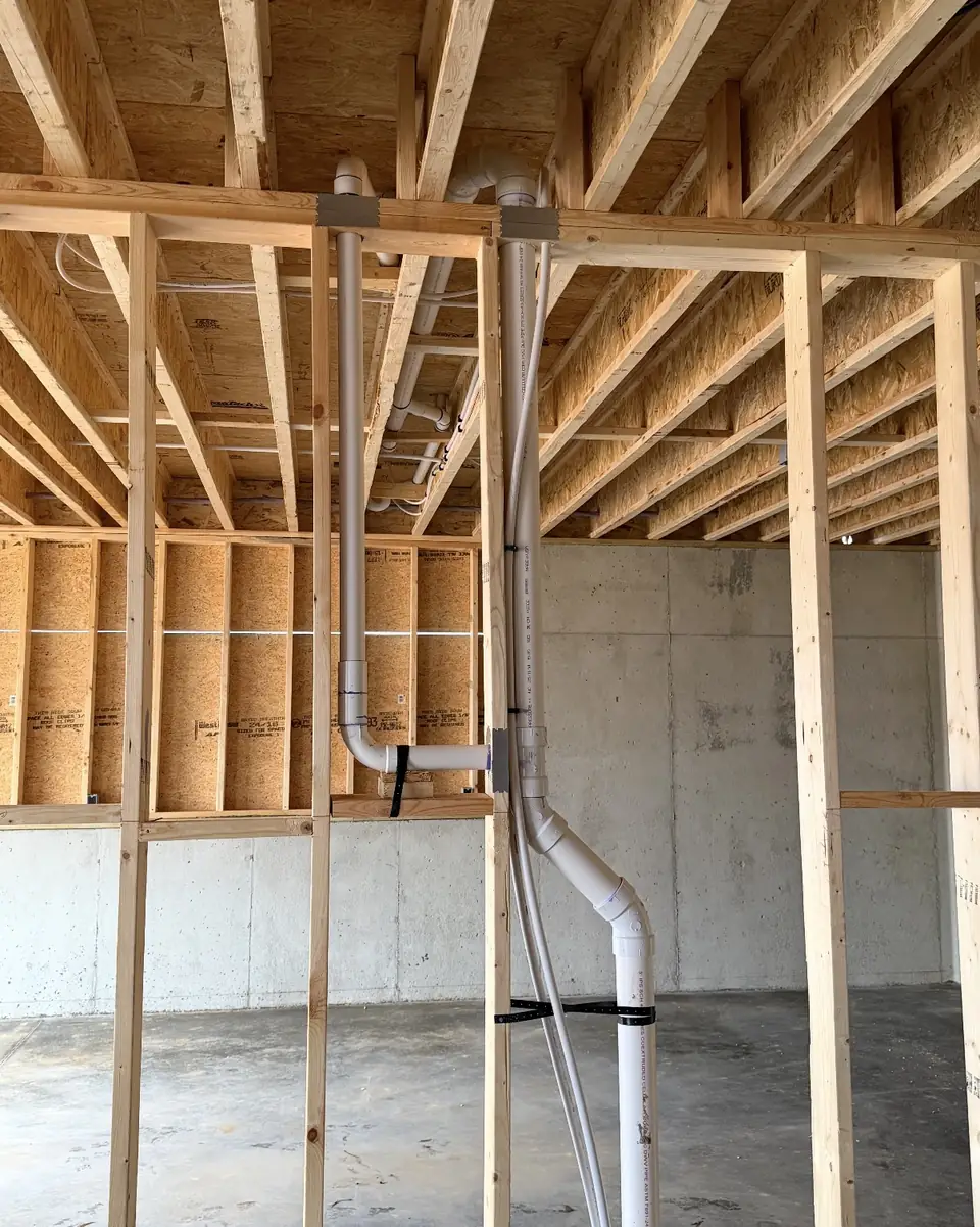 Drain stack in a basement wall
