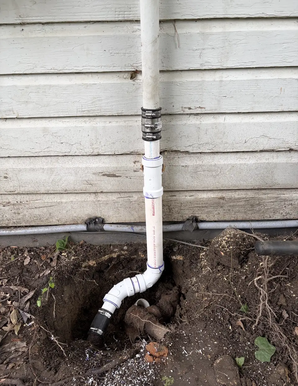 Sewer line dug up and replaced beside a house